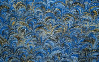 Blue and gold marbled paper with a feathered pattern, a classic choice for decorative endpapers